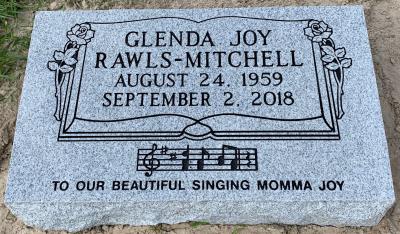 individual gray granite headstone with Bible and Roses Panel and a Musical Notes Emblem